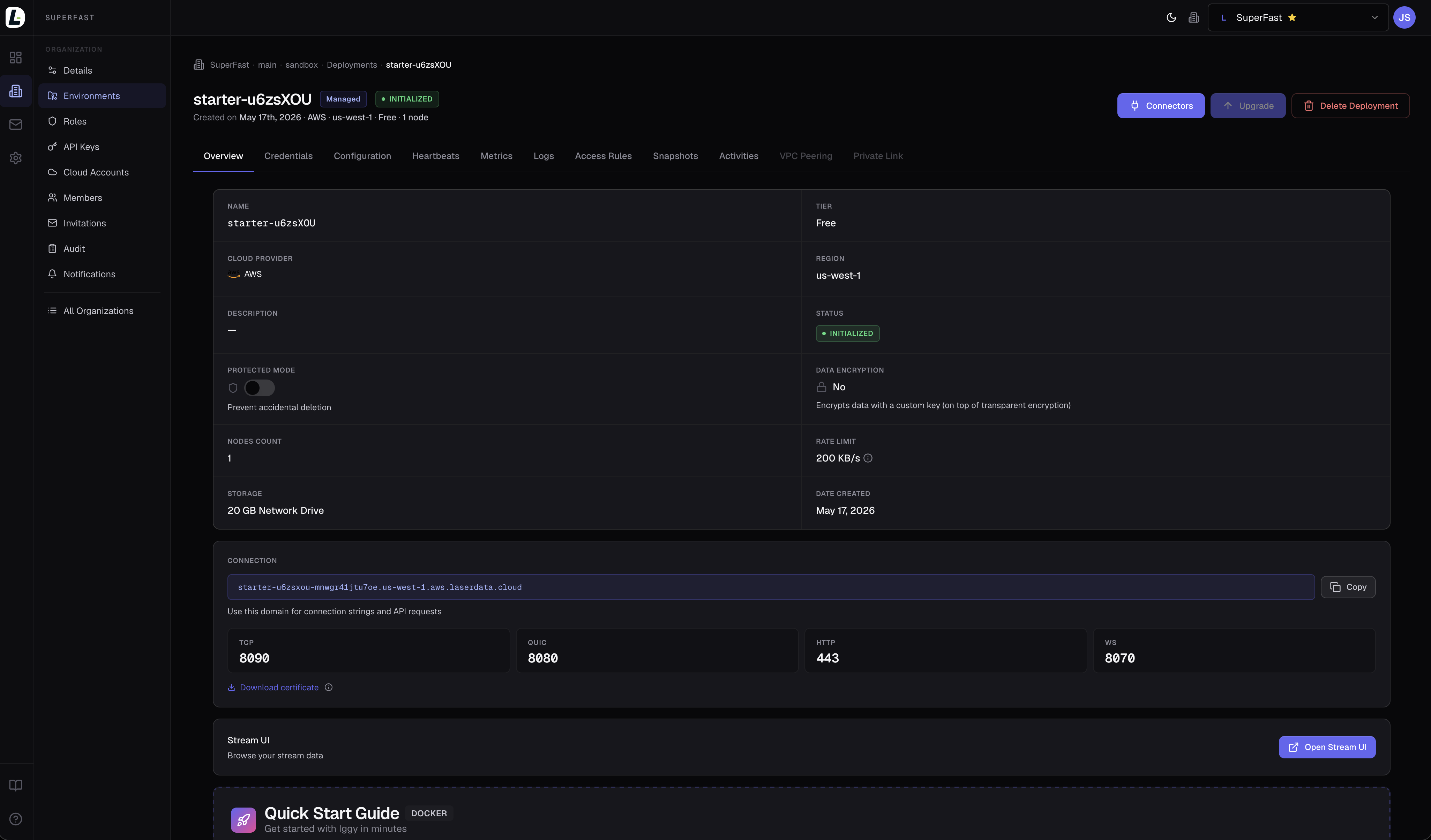 LaserData Console showing the starter-u6zsXOU deployment in INITIALIZED state: tier, cloud, region, storage, connection string, per-protocol ports (TCP, QUIC, HTTP, WS) and the Quick Start Guide card.